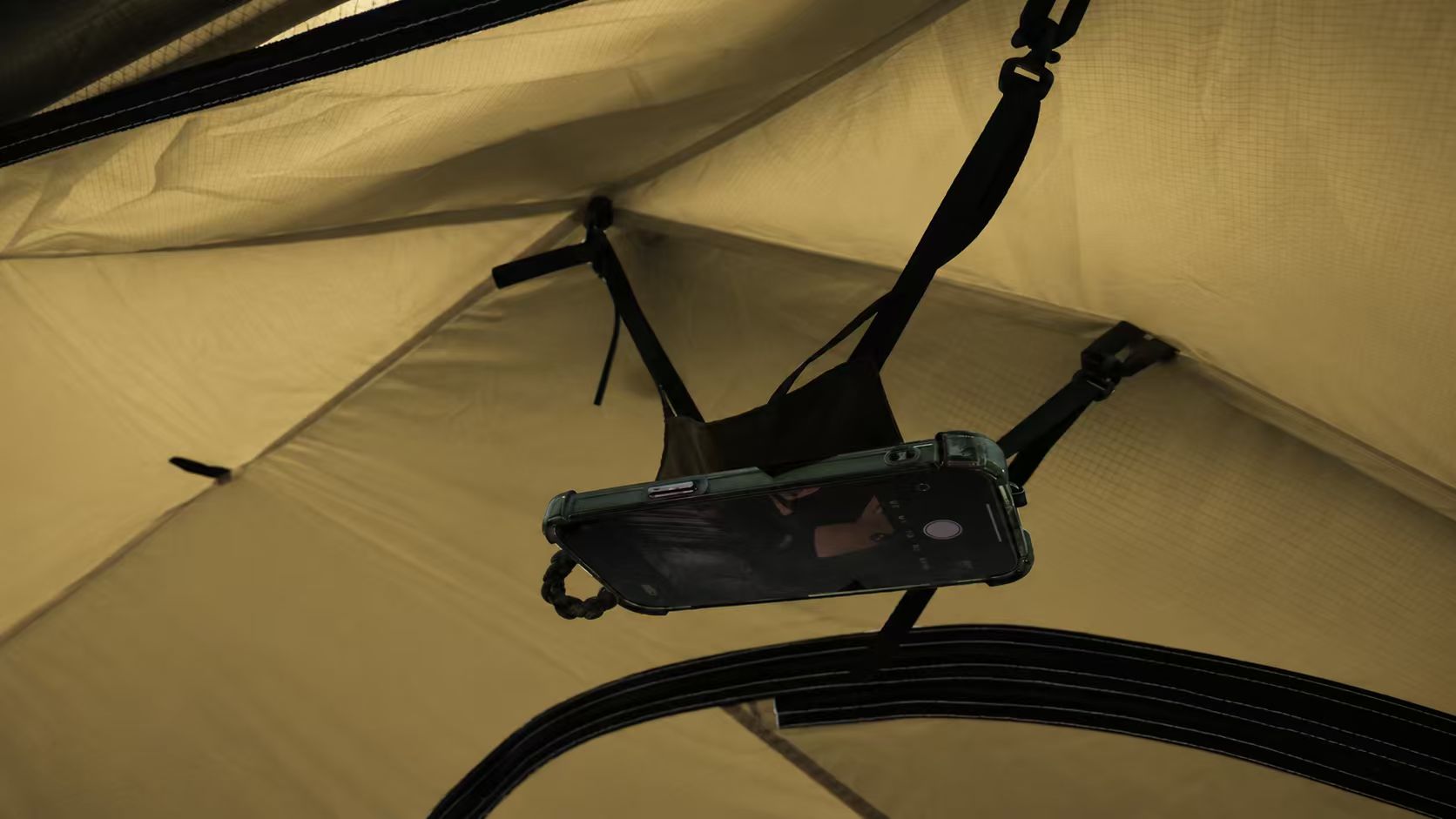 The adjustable phone holder used inside a tent