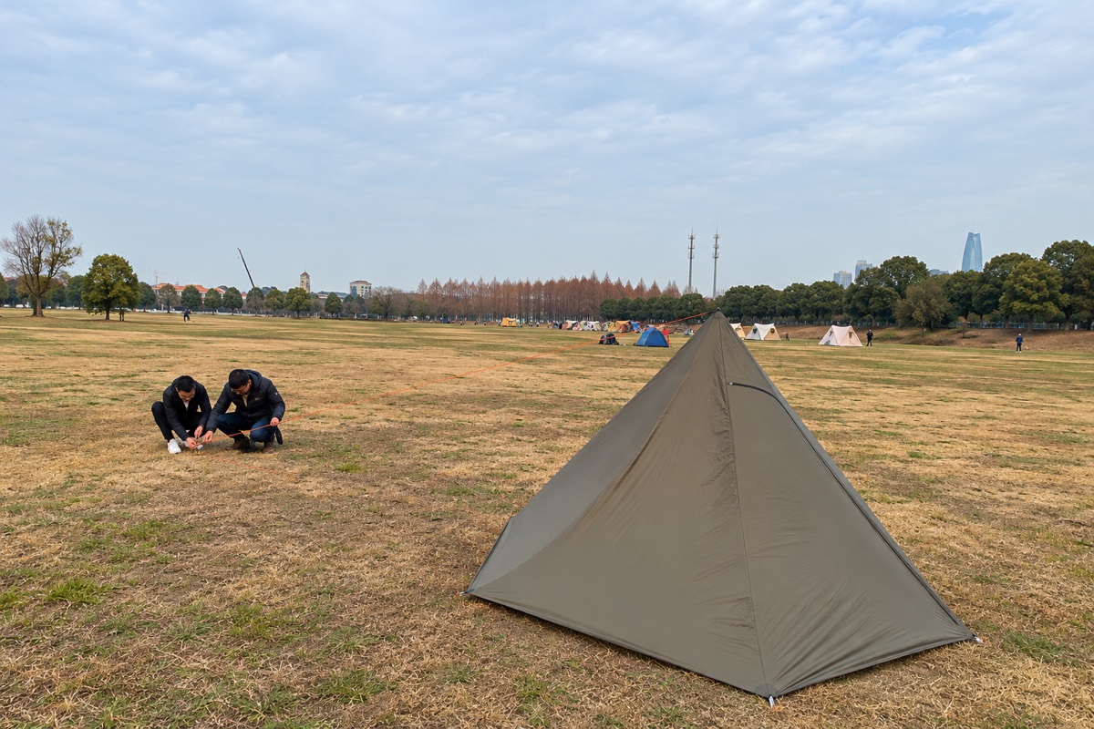 Michael testing the One-Side Pole Teepee at a camping field.